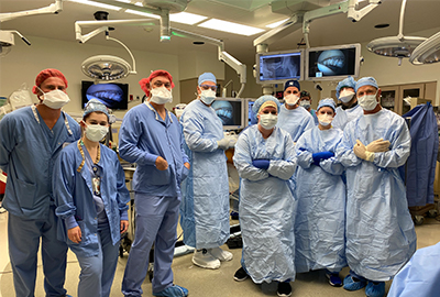 Dr. White and his team in scrubs in the surgery room.